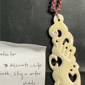 Carved Cream Pendant with Intricate Design
